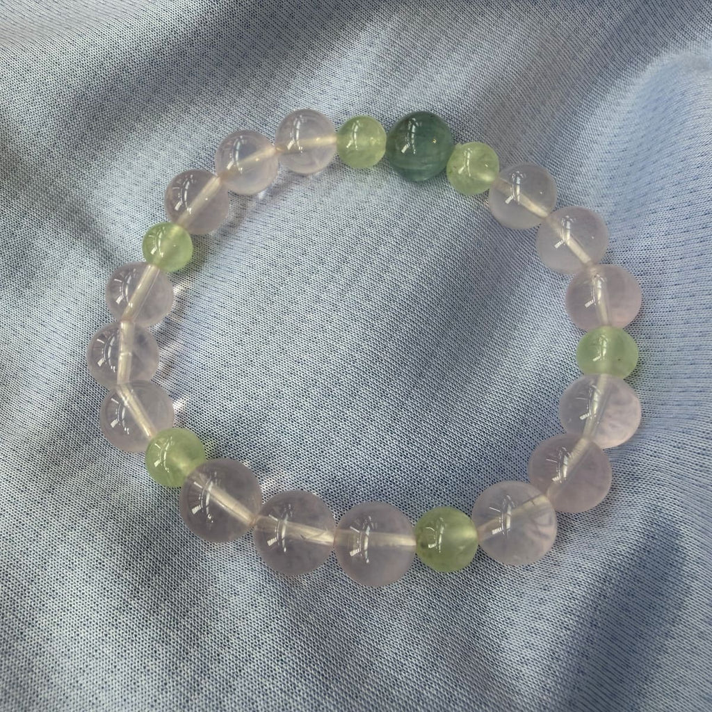 Rose quartz, prehnite and aquamarine generating-cycle combo bracelet on dark cloth