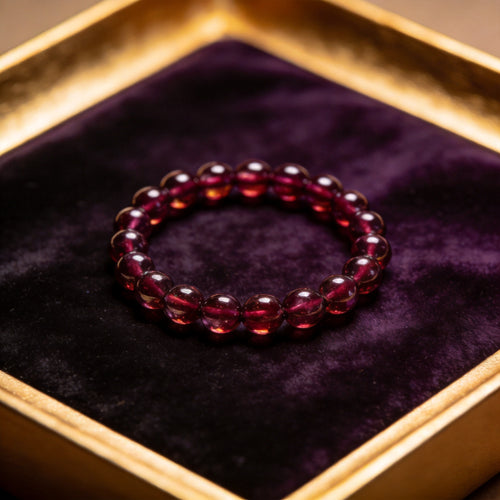 Garnet Women's 8mm natural stone bracelet on dark velvet