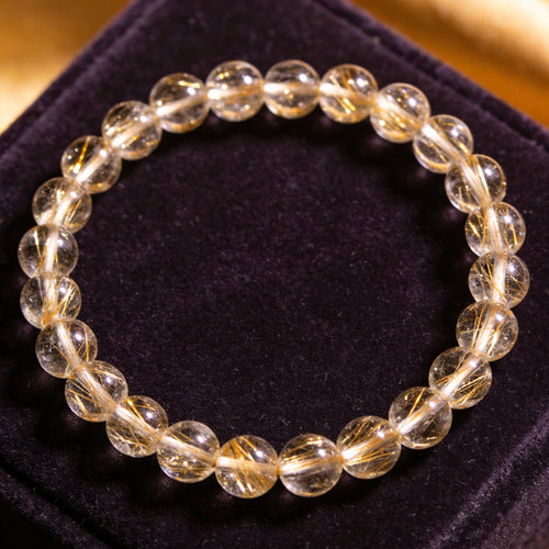 Gold Rutilated Quartz Women's 8mm natural stone bracelet on dark velvet