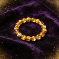 Golden Tiger Eye Women's 8mm natural stone bracelet on dark velvet