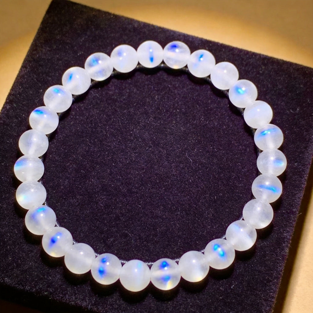 Moonstone Women's 8mm natural stone bracelet on dark velvet