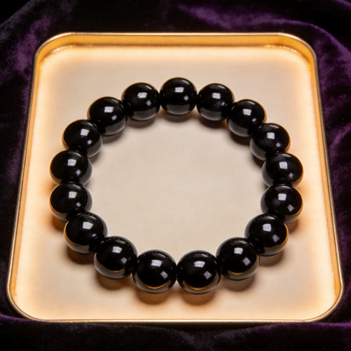 Black Obsidian Men's 12mm natural stone bracelet on dark velvet
