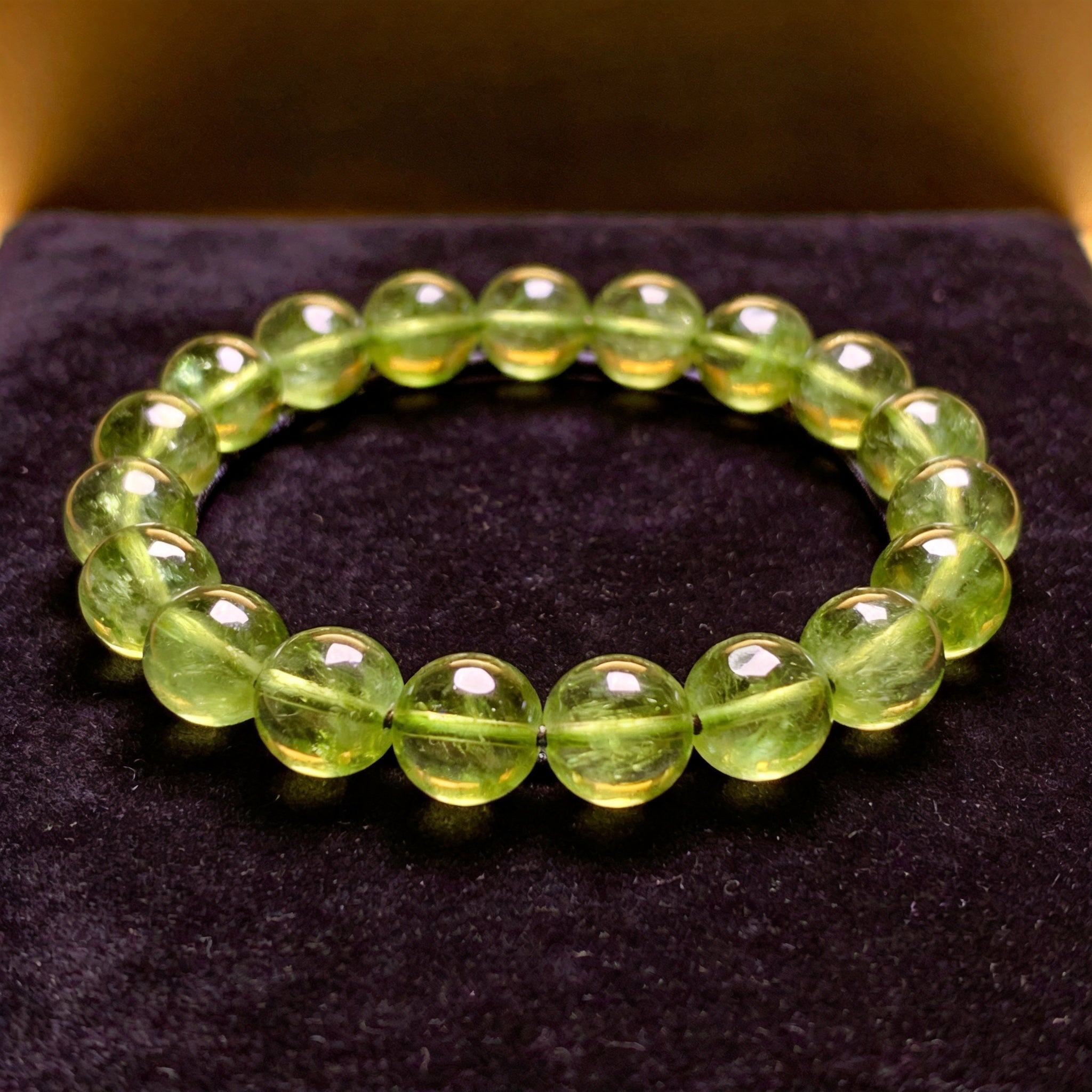 Peridot Men's 12mm natural stone bracelet on dark velvet